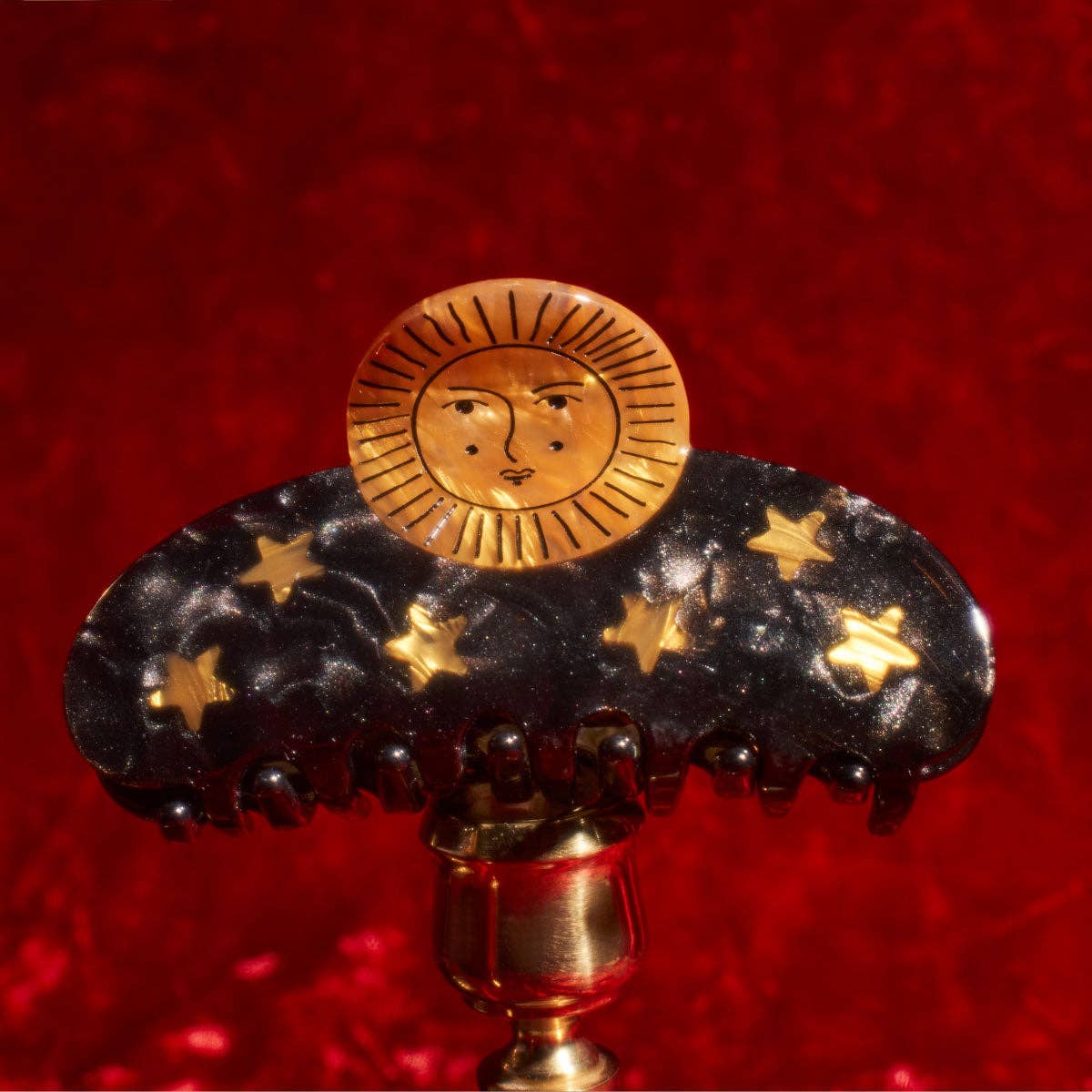 Pinza para el pelo con diseño astrológico del sol y las estrellas en acetato dorado y negro