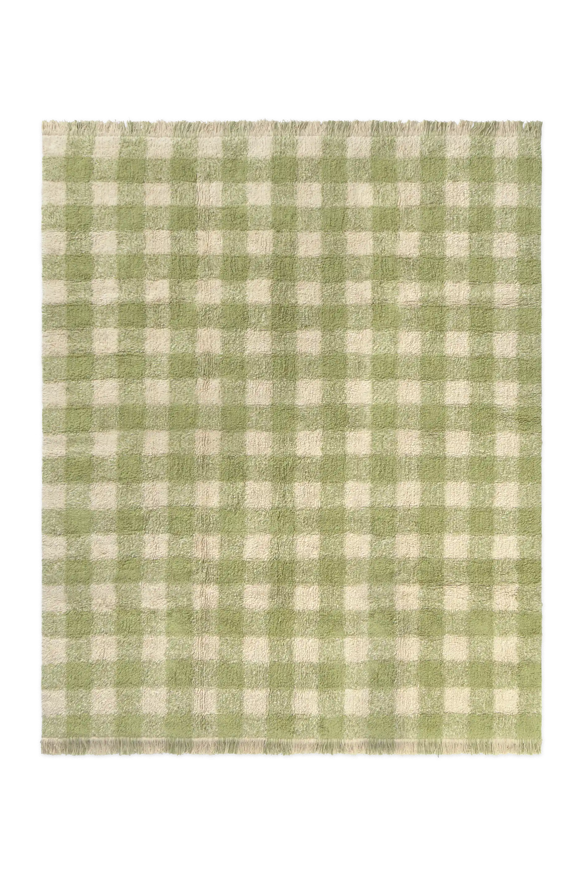 Alfombra lavable Vichy de Lorena Canals con cuadros en matcha y tono natural y flecos en los extremos.